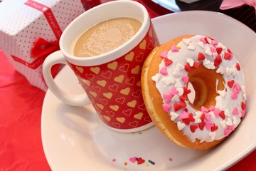Coffee and a glazed donut with sprinkles