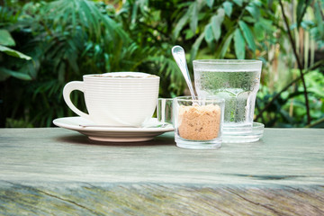 White cup of coffee, water and cane sugar