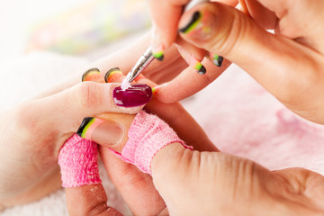 Manicure treatment in cosmetic salon.