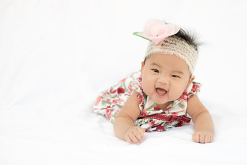 Cute baby smiling girl with rose headband