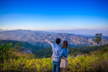 Fototapeta na wymiar couple with view of mountain and crop field in north Thailand