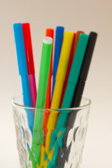 colorful pens in a glass