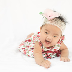 Cute baby smiling girl with rose headband