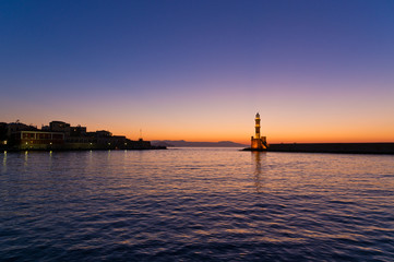 View of Chania harbor with lighthouse at sunset,Crete