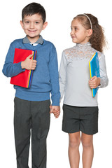 Smiling young boy and girl with books