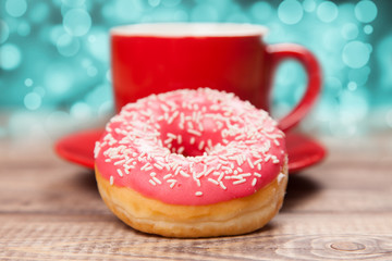 Tasty donut with a cup of coffee