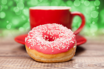 Tasty donut with a cup of coffee