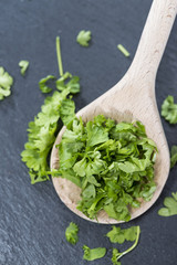 Cutted Parsley on a wooden spoon