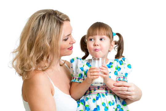 Kid Drinking Milk. Mother Looks To Daughter.