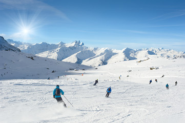 Skiers enjoy in the mountain on a sunny day