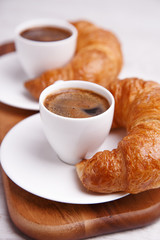Breakfast cups of coffee and croissants