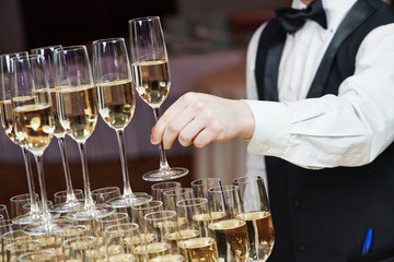 Waiter with glass of champagne