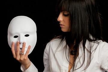 beautiful woman staring at a white mask