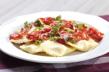 Portion of ravioli with tomato sauce