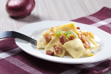 Portion of ravioli with onion and bacon