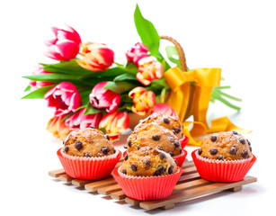 Muffins with tulips isolated on white background