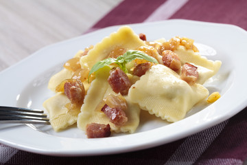 Portion of ravioli with onion and bacon