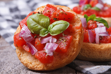 two Italian bruschetta with tomato, onion and basil