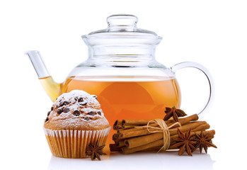Glass teapot with spices and cake isolated