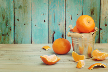 Bowl of mandarins on old blue wooden background
