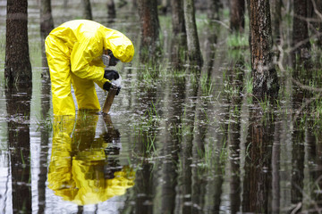 taking sample of water to container in floods contaminated area