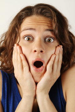 Portrait of a surprised young woman with curly hair