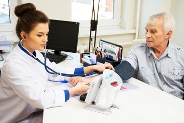 Senior man measuring blood pressure at doctor's office