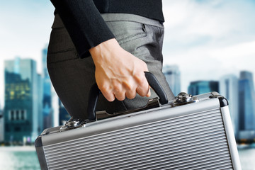 Business woman holding an aluminium briefcase - obrazy, fototapety, plakaty