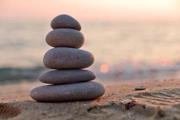 Fotobehang Zen Stenen Stacked stones on the beach at sunset  © niki spasov