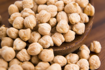 dried white chickpeas ceci on the wooden spoon