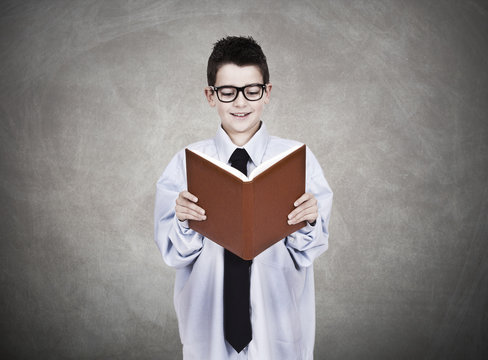 young man in business clothes with open book reading