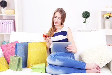 Obraz na płótnie Canvas Young woman sitting with tablet