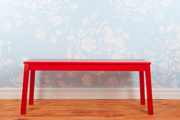 Room with blue vintage wall paper and red bench