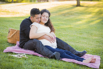 Pregnant Hispanic Couple in The Park Outdoors