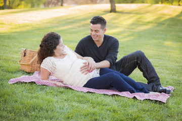 Pregnant Hispanic Couple in The Park Outdoors