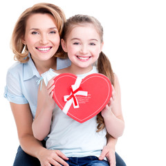 happy mother and young daughter hold gift for birthday