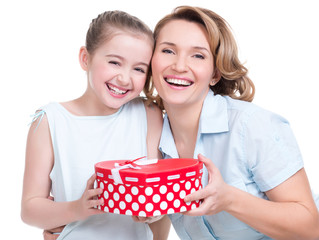 happy  white mother and young daughter hold present