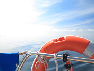 Rescue red lifebuoy on sail and blue sky sea
