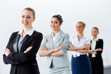 Four businesswomen standing in row