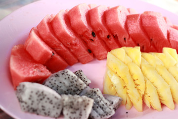 Various fruit slices on plate.