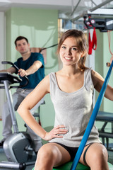 Fototapeta premium Smiling girl in fitness center