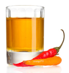 glass of pepper vodka and red chili peppers isolated on white