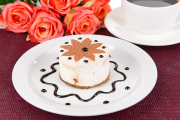 Sweet cake with chocolate on plate on table close-up