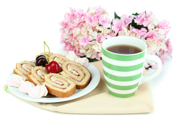 Cup of tea and sweets isolated on white