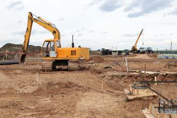 yellow excavator on a construction site