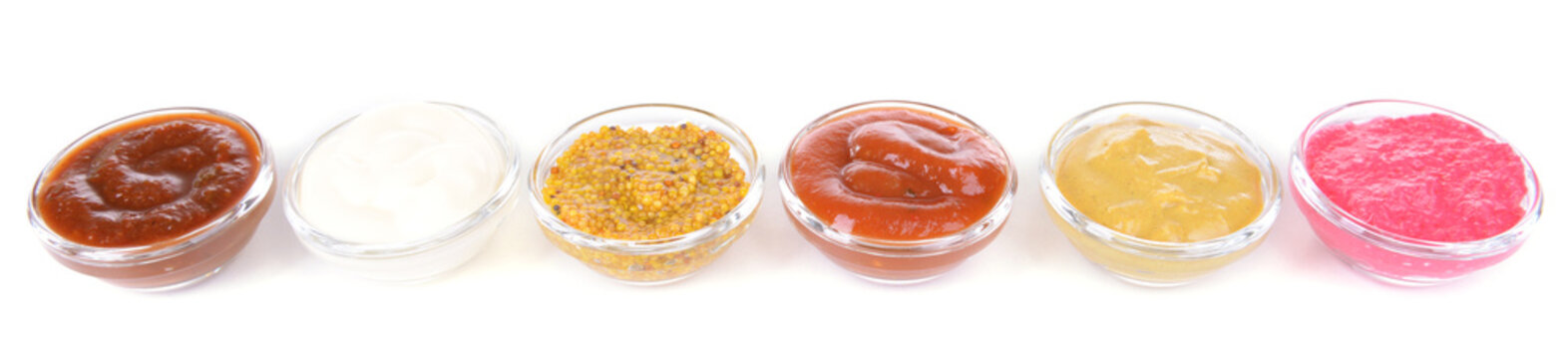 Various sauces isolated on white