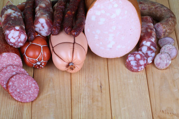 Different sausages on wooden table close-up