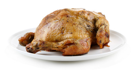 Whole roasted chicken on plate, isolated on white
