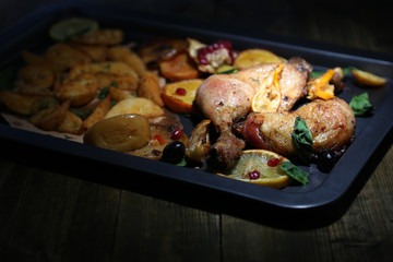 Homemade roasted chicken drumsticks with fried potatoes and