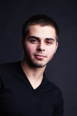 Fototapeta premium Handsome young man on dark background
